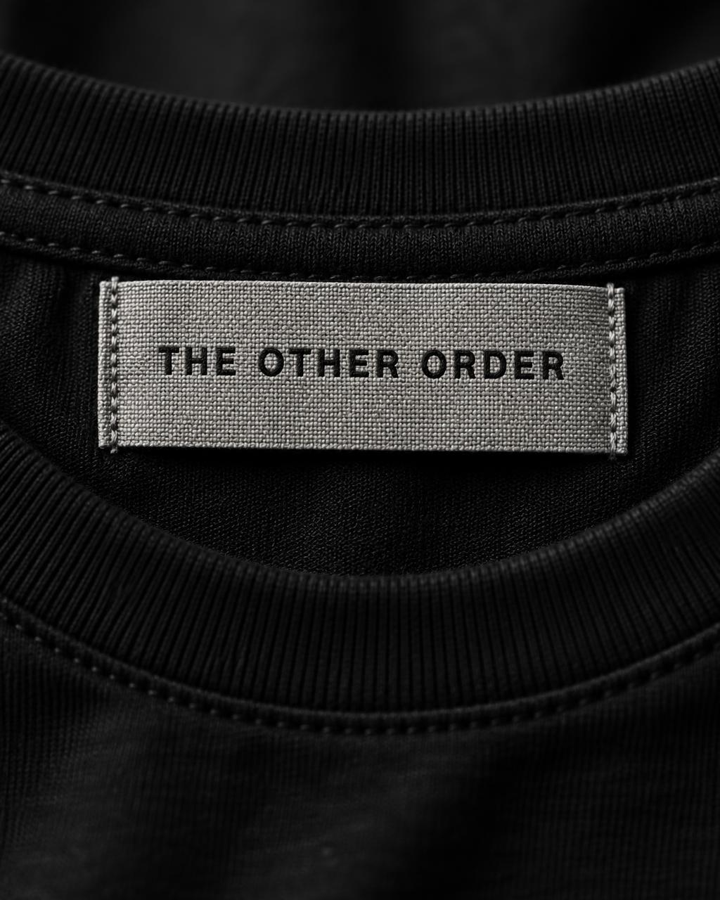 Woven label detail on black jersey